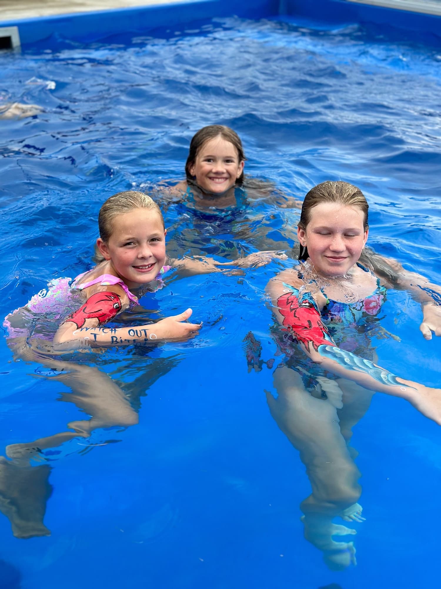 Body art on swimmers in a pool