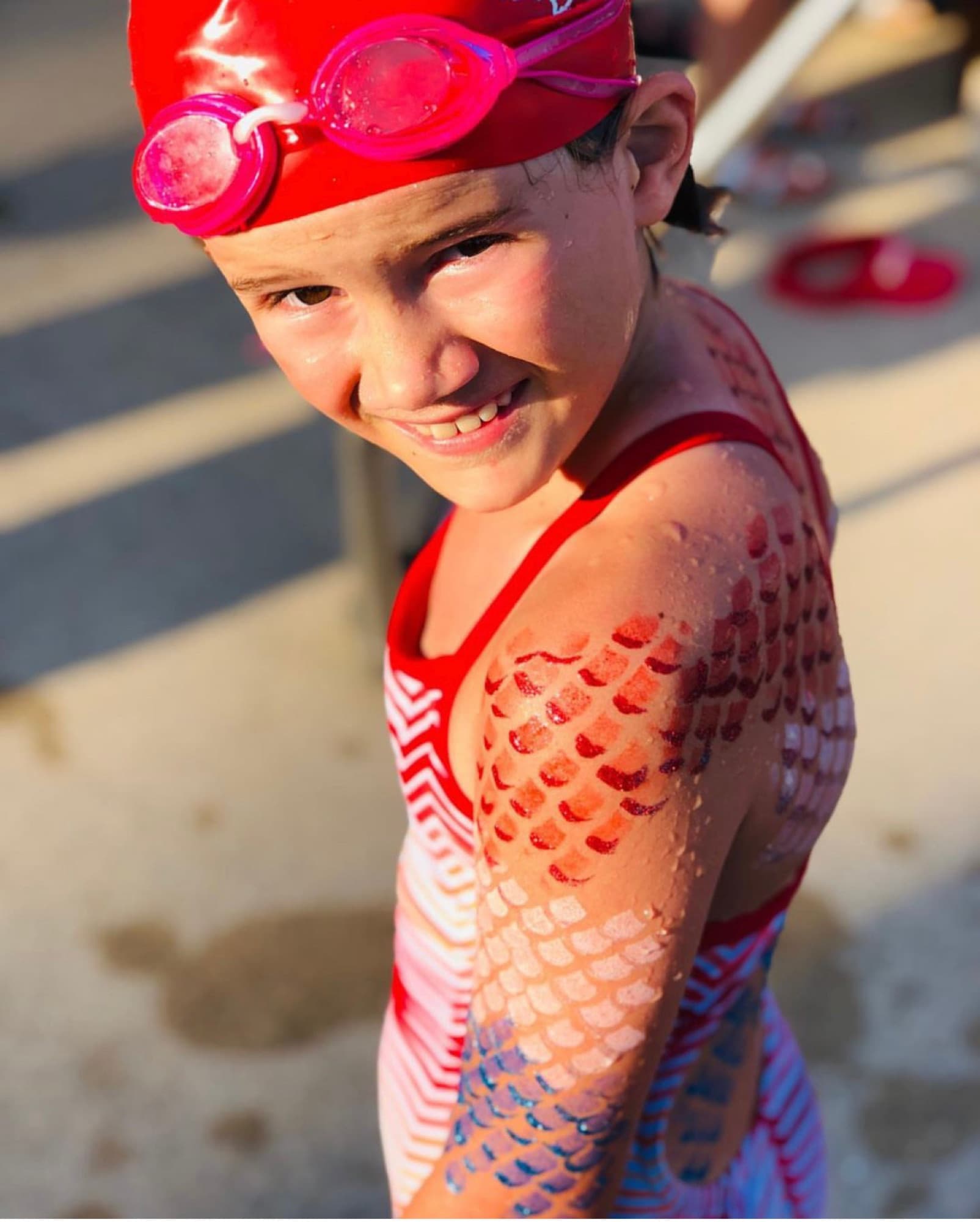 Red mermaid scales on a swimmer