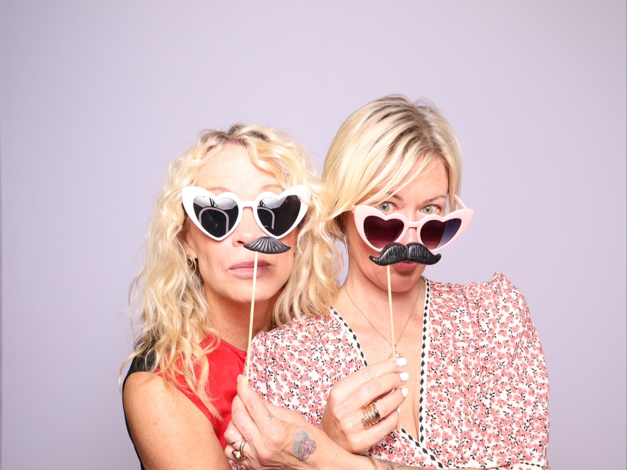 Friends with heart glasses and mustache props