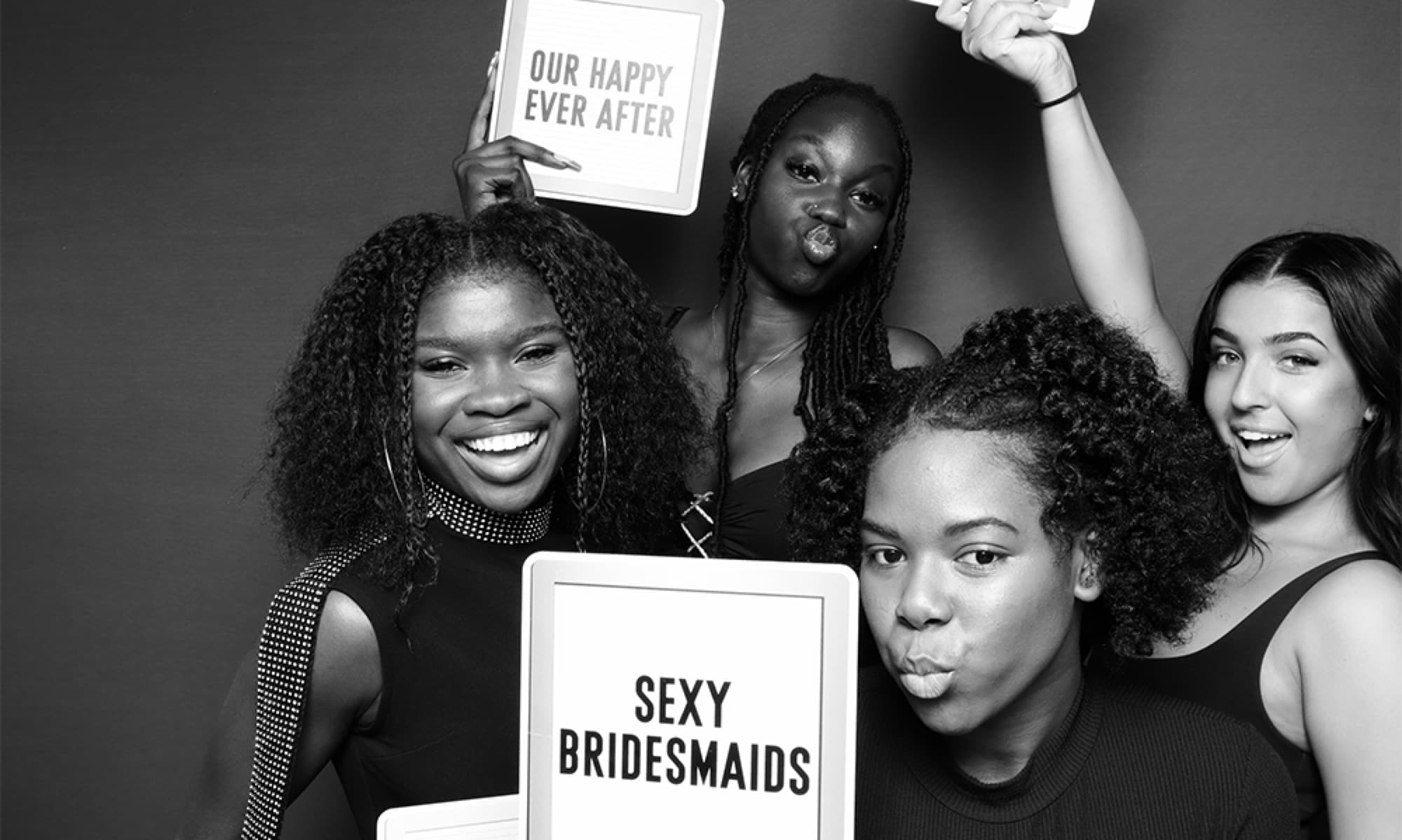 Bridesmaids with sign props